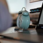 An alarm clock and a laptop