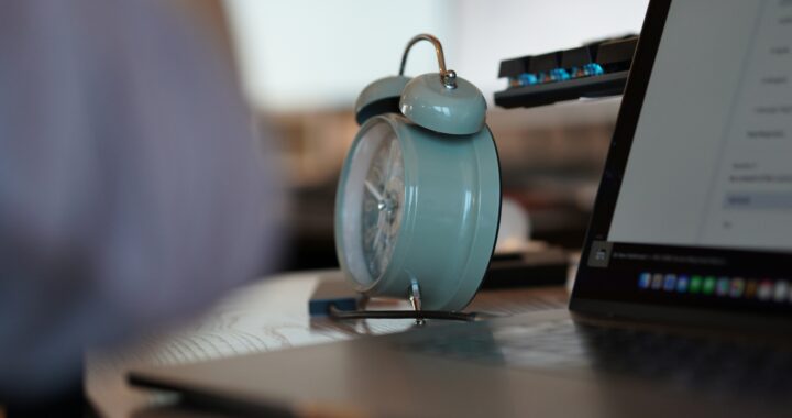 An alarm clock and a laptop